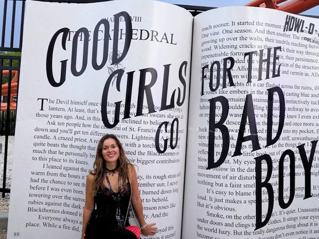 Kaleigh in front of a giant open book photo op reading Good Girls Go for the Bad Boy at Howl-O-Scream